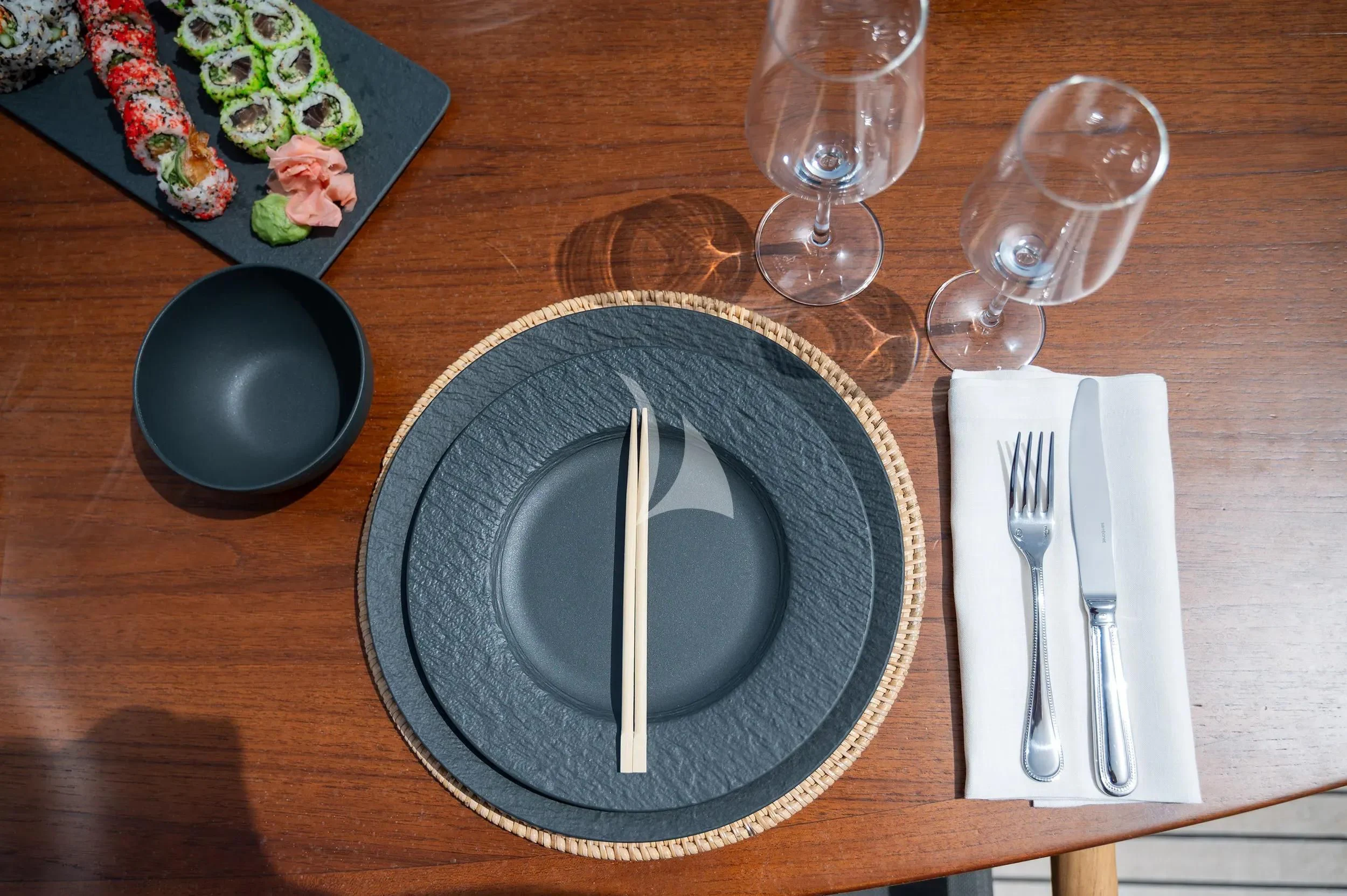 a plate with silverware on a table with silverware aboard PAREAKI II Yacht for Sale