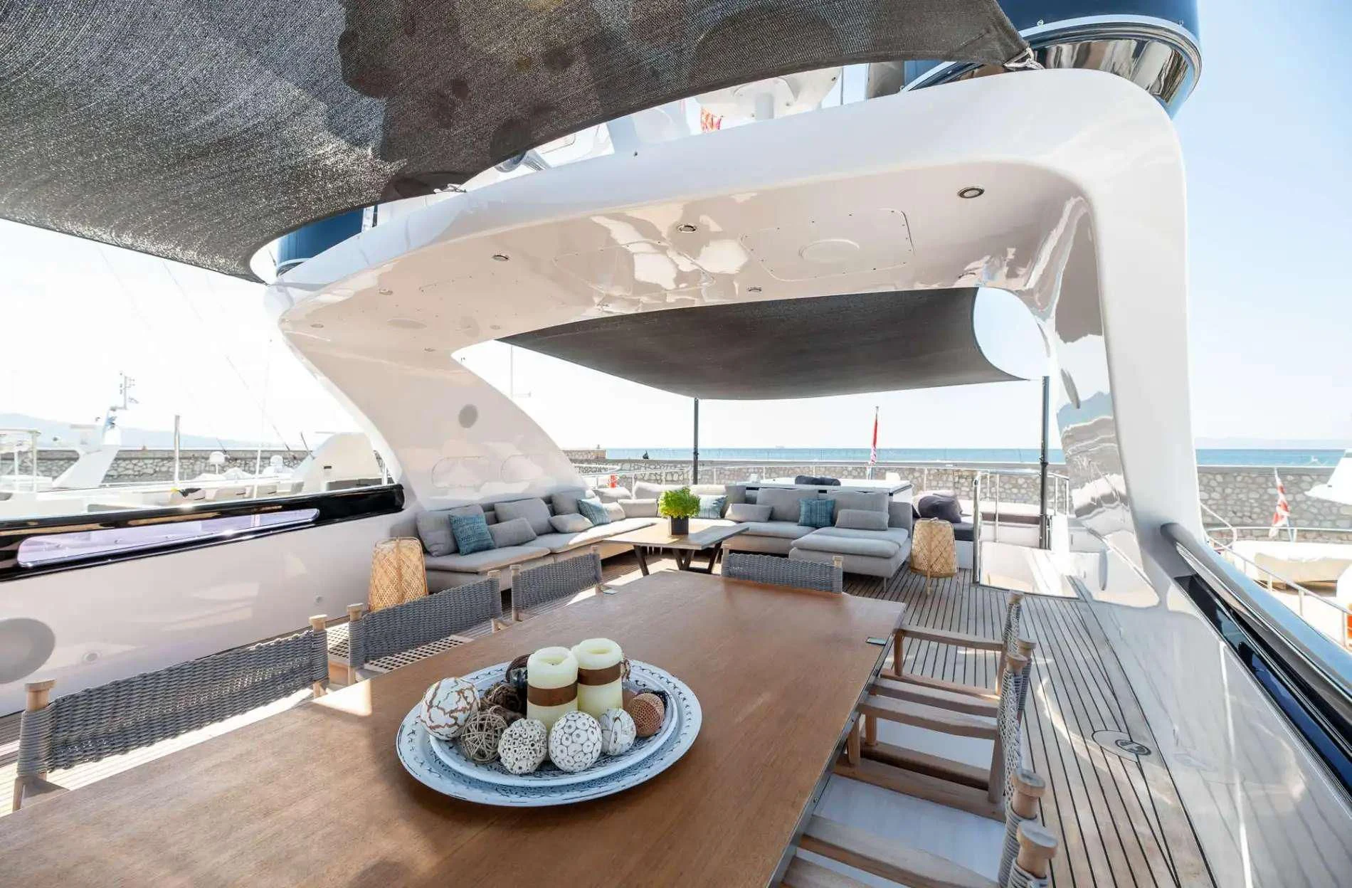 a balcony with a table and chairs aboard PAREAKI II Yacht for Sale