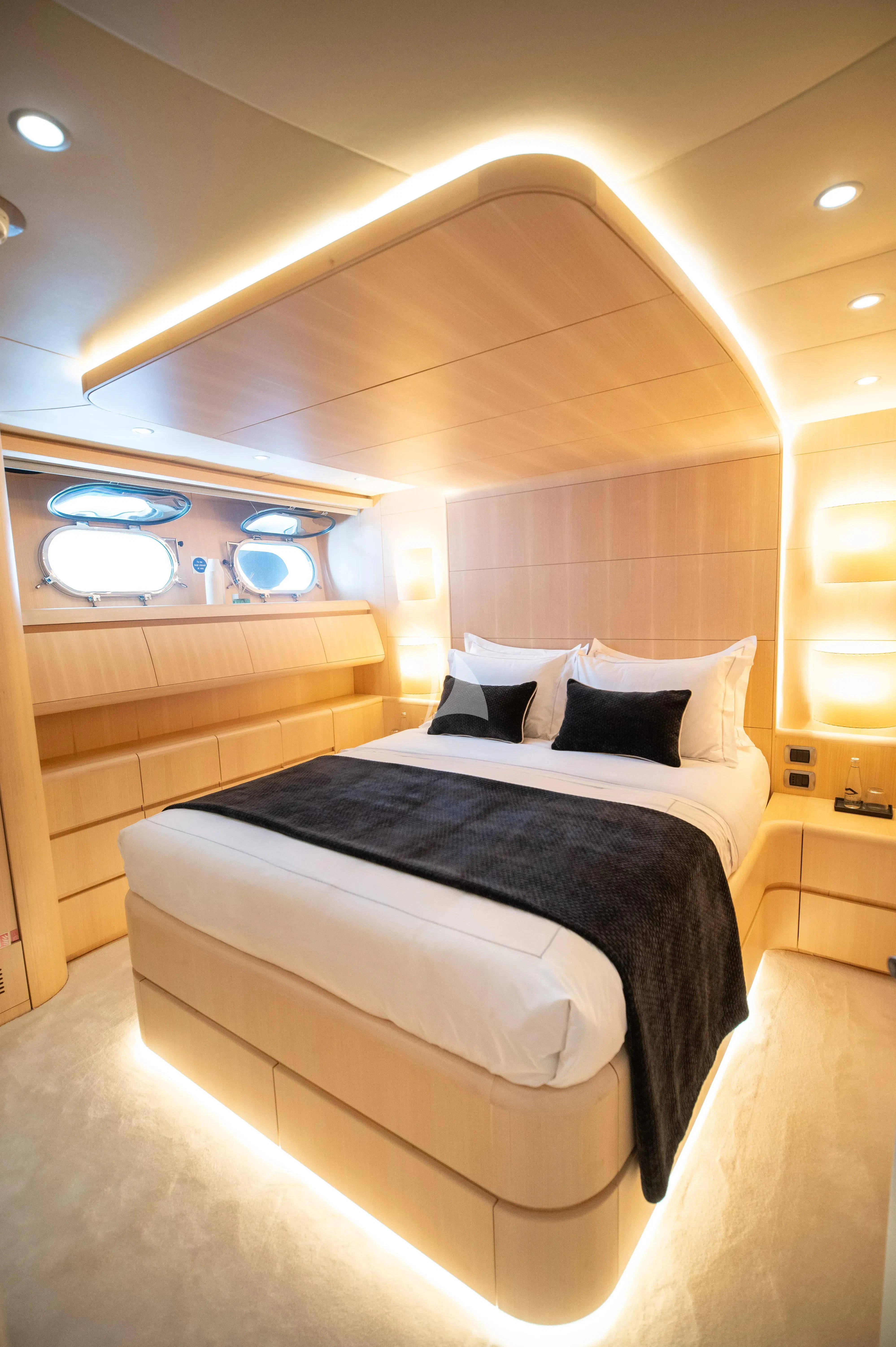 a bed with a black and white bed spread aboard PAREAKI II Yacht for Sale