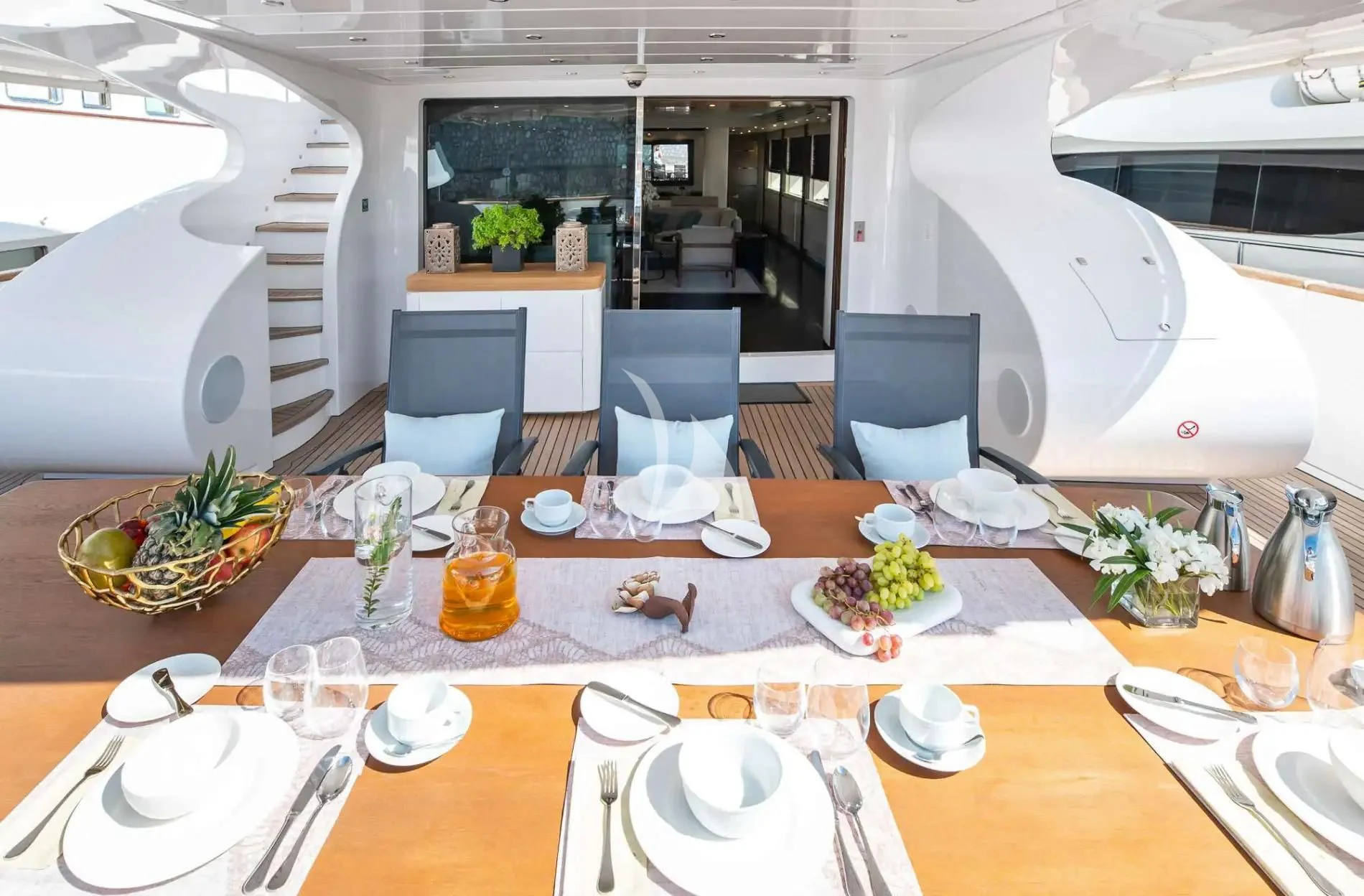 a table set with plates and glasses aboard PAREAKI II Yacht for Sale