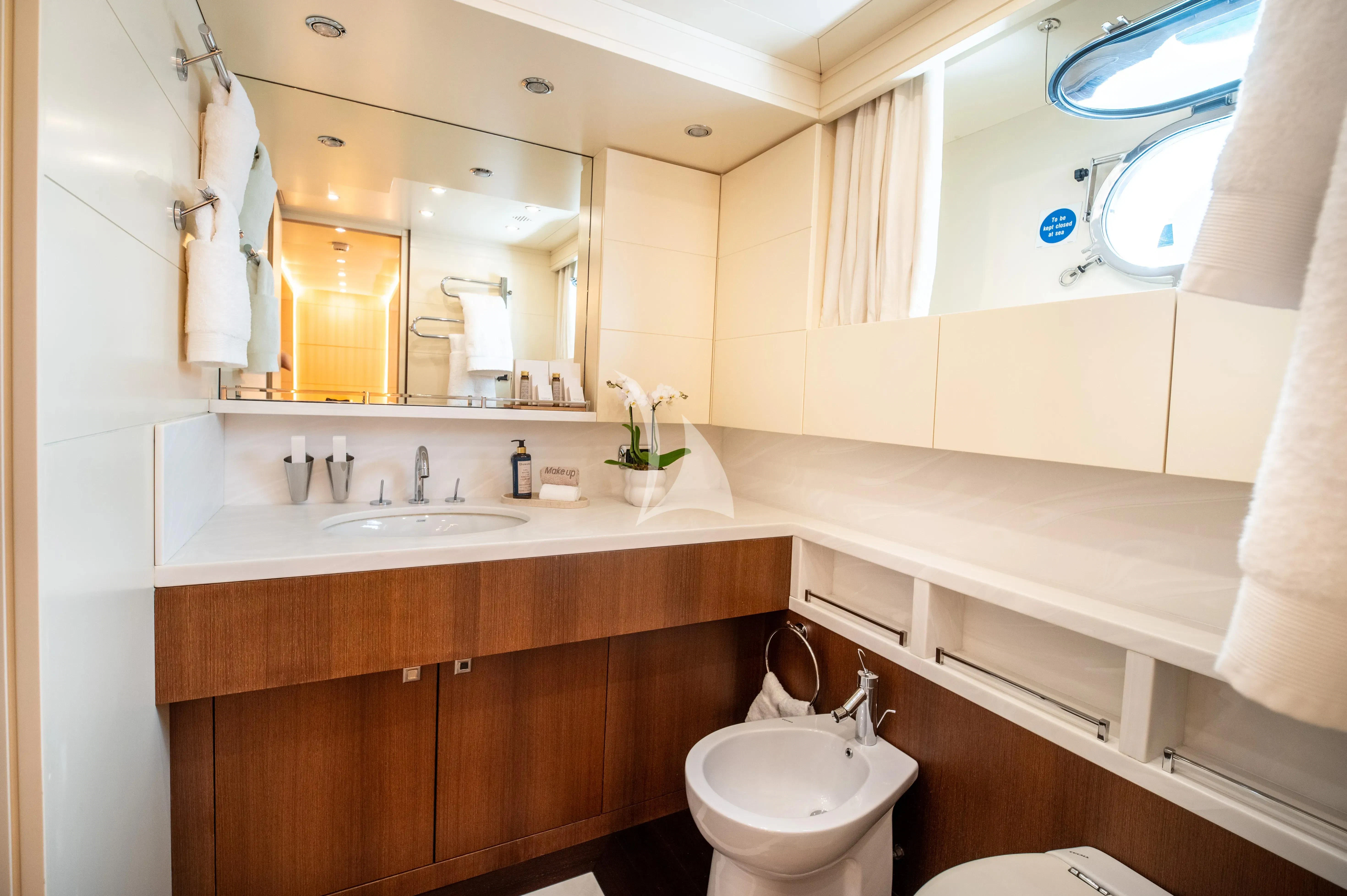 a bathroom with a large mirror aboard PAREAKI II Yacht for Sale