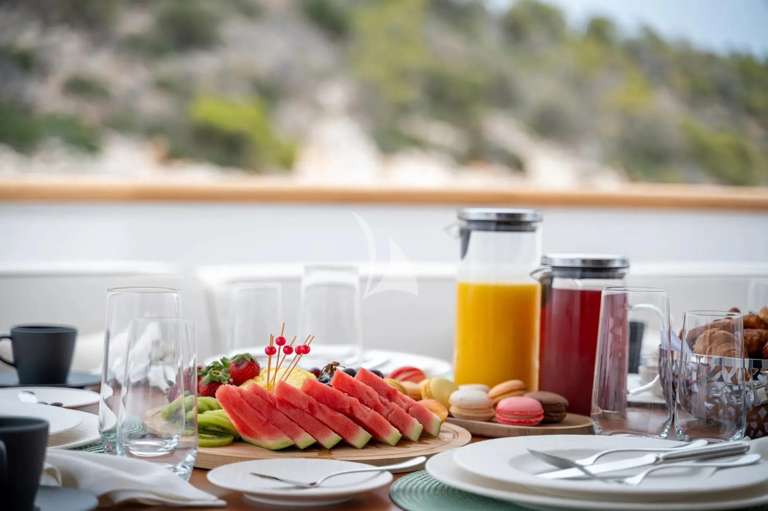 a table with food and drinks aboard PAREAKI II Yacht for Sale