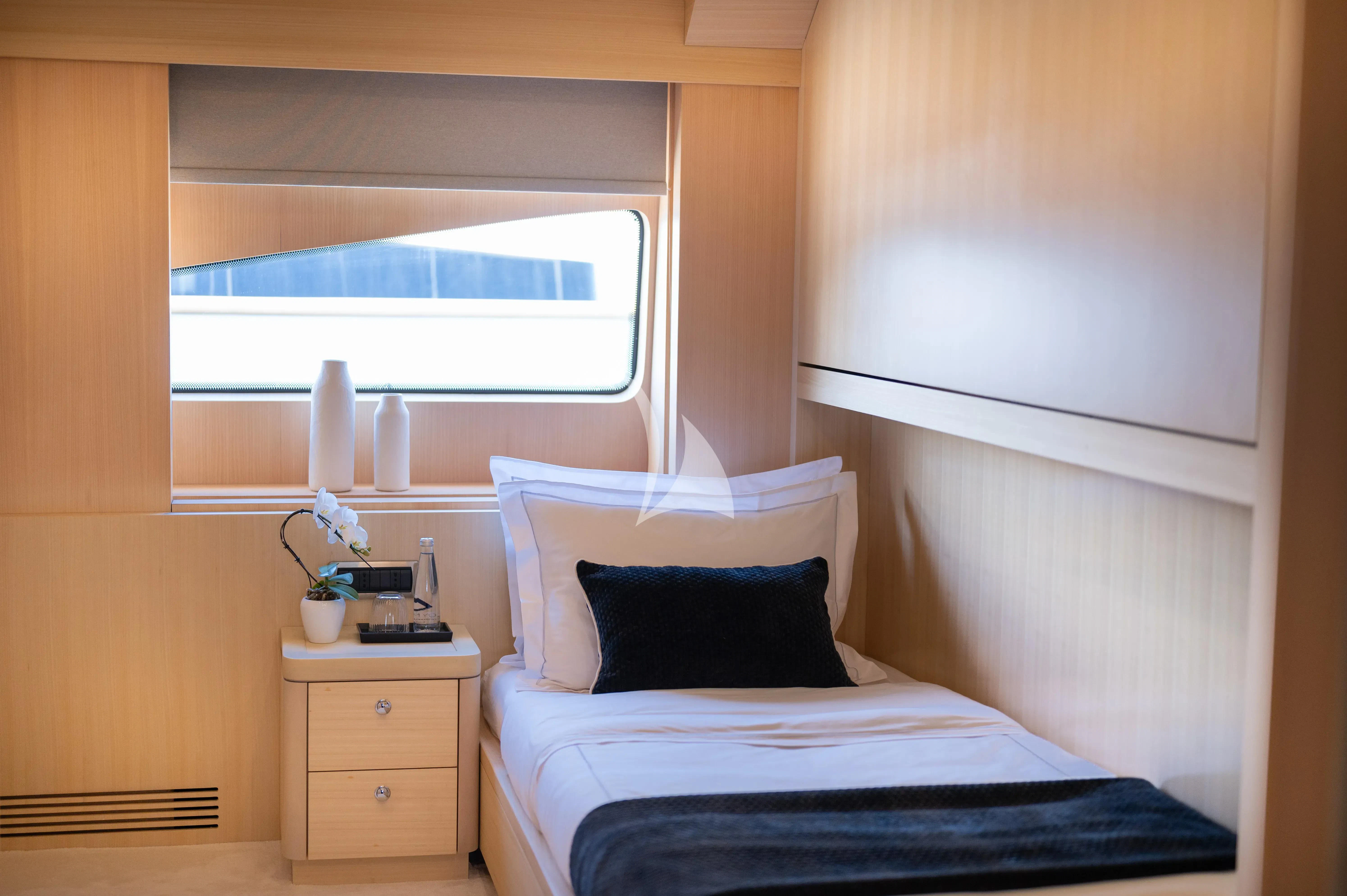 a room with a bed and a window aboard PAREAKI II Yacht for Sale