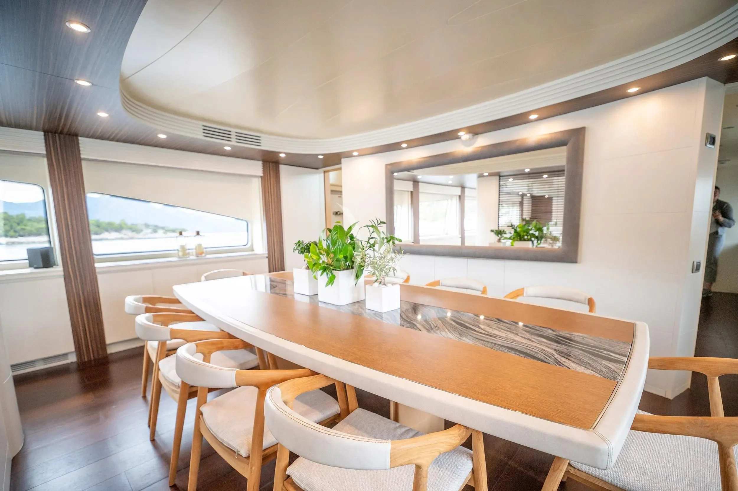 a room with tables and chairs aboard PAREAKI II Yacht for Sale