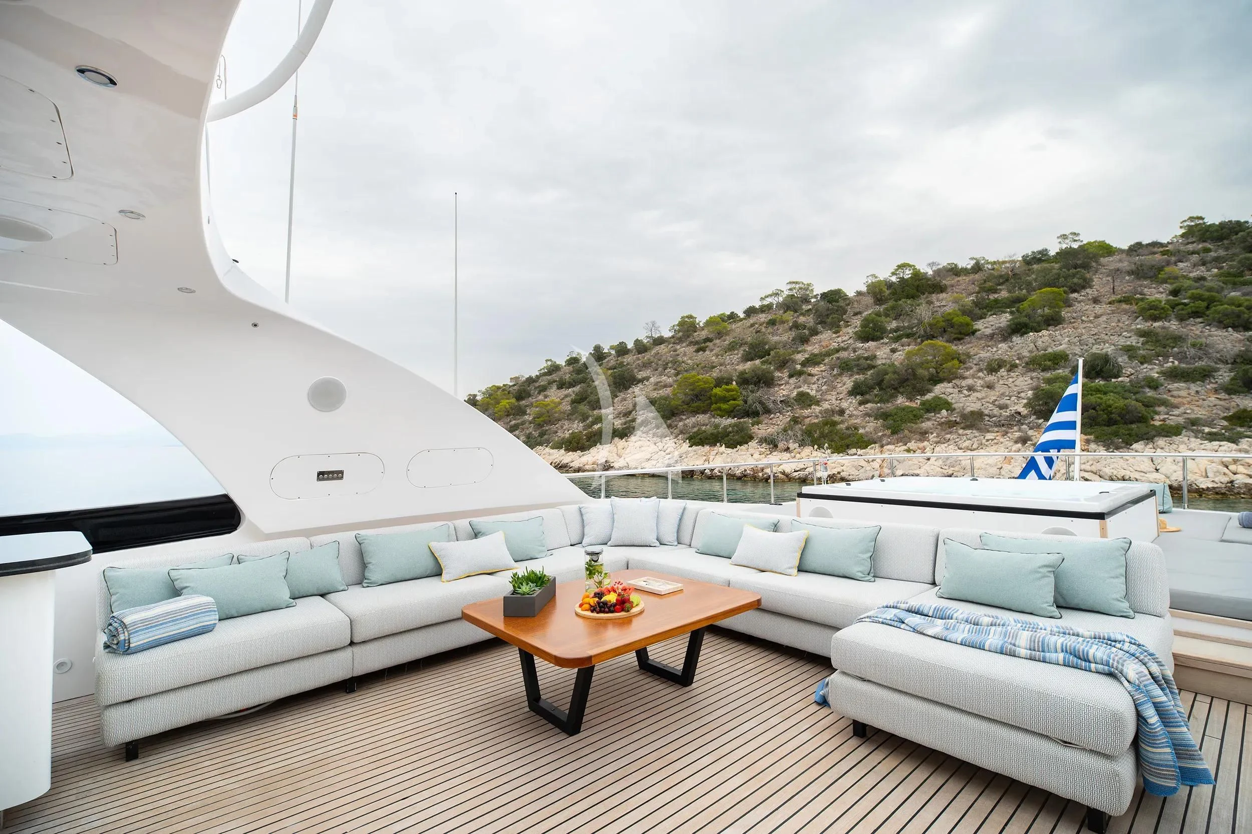 a room with a couch and a table and a view of the ocean aboard PAREAKI II Yacht for Sale