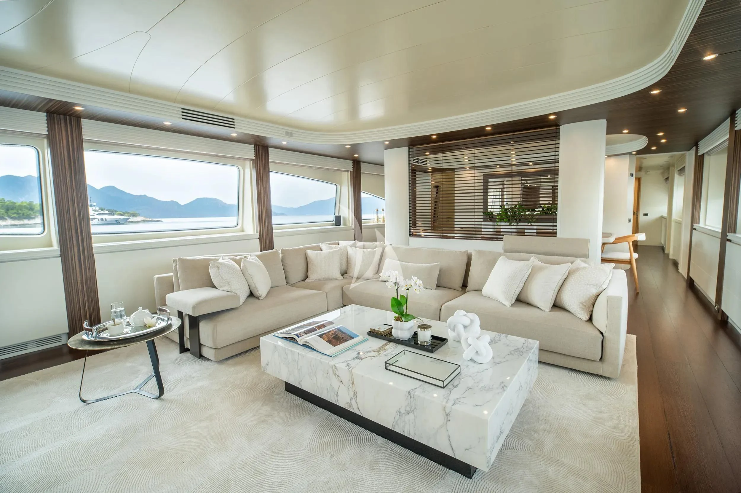 a living room with a large window aboard PAREAKI II Yacht for Sale