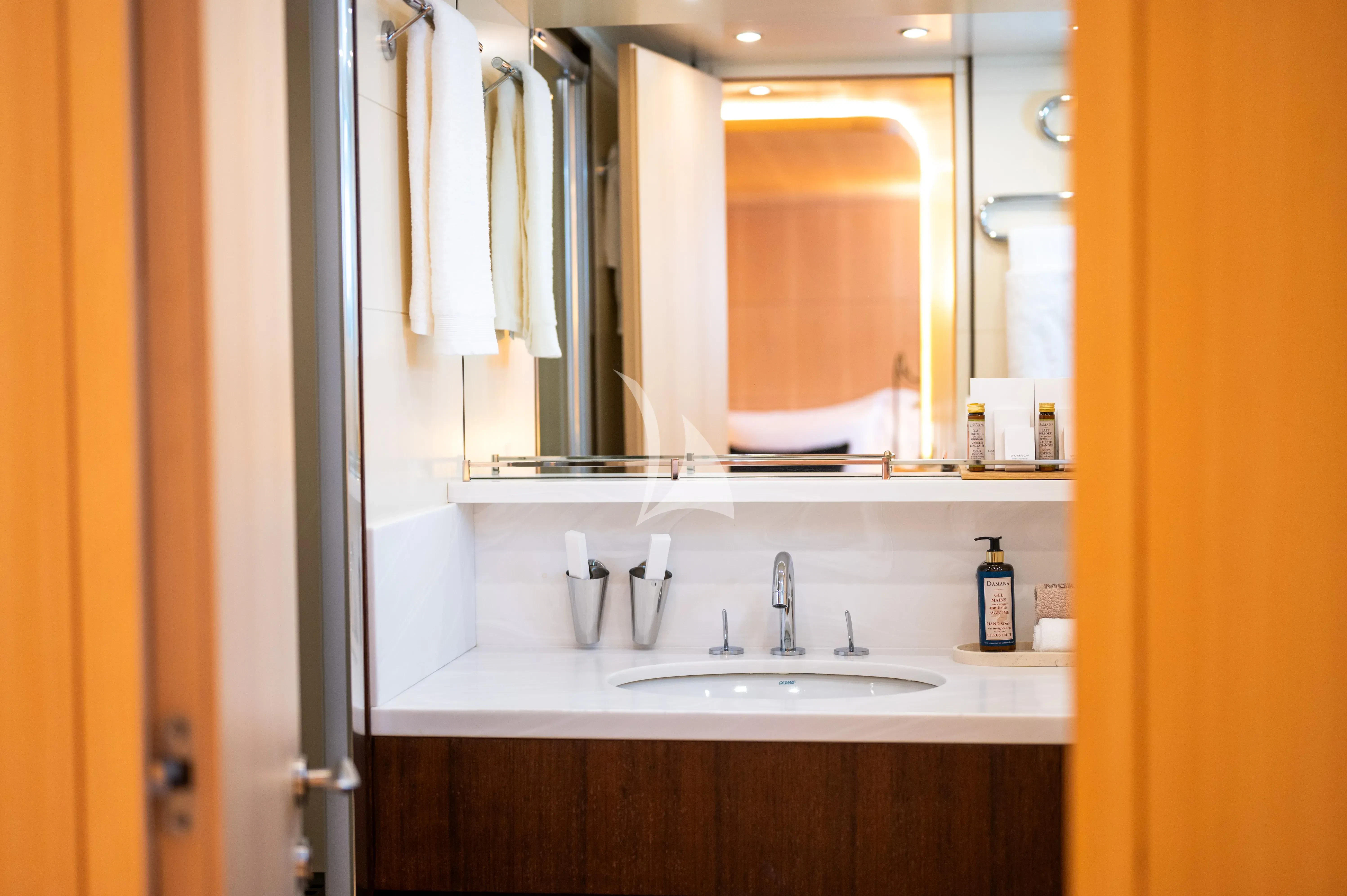 a bathroom with a sink and mirror aboard PAREAKI II Yacht for Sale
