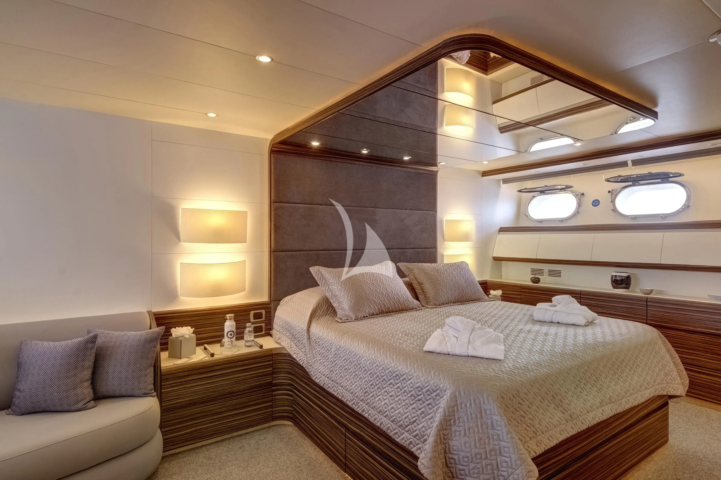 a bedroom with a bed and a couch aboard PAREAKI II Yacht for Sale