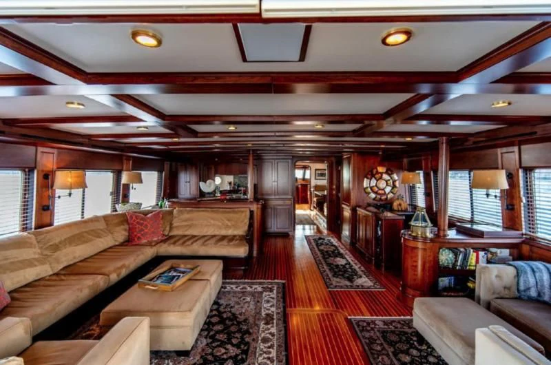 a living room with leather couches aboard HER IDEA Yacht for Sale