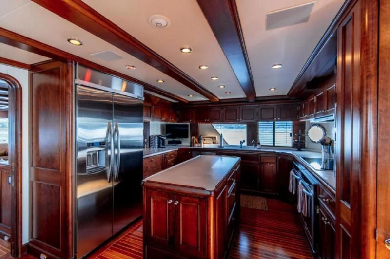 a kitchen with a large refrigerator aboard HER IDEA Yacht for Sale