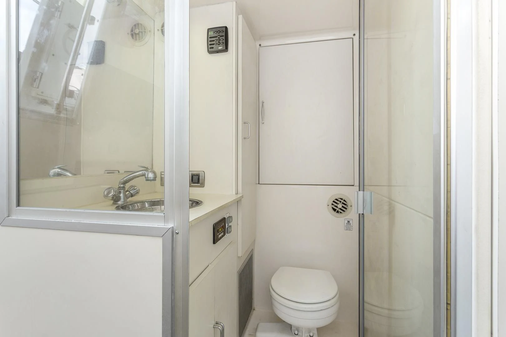 a bathroom with a toilet and sink aboard MONDRIAN Yacht for Sale