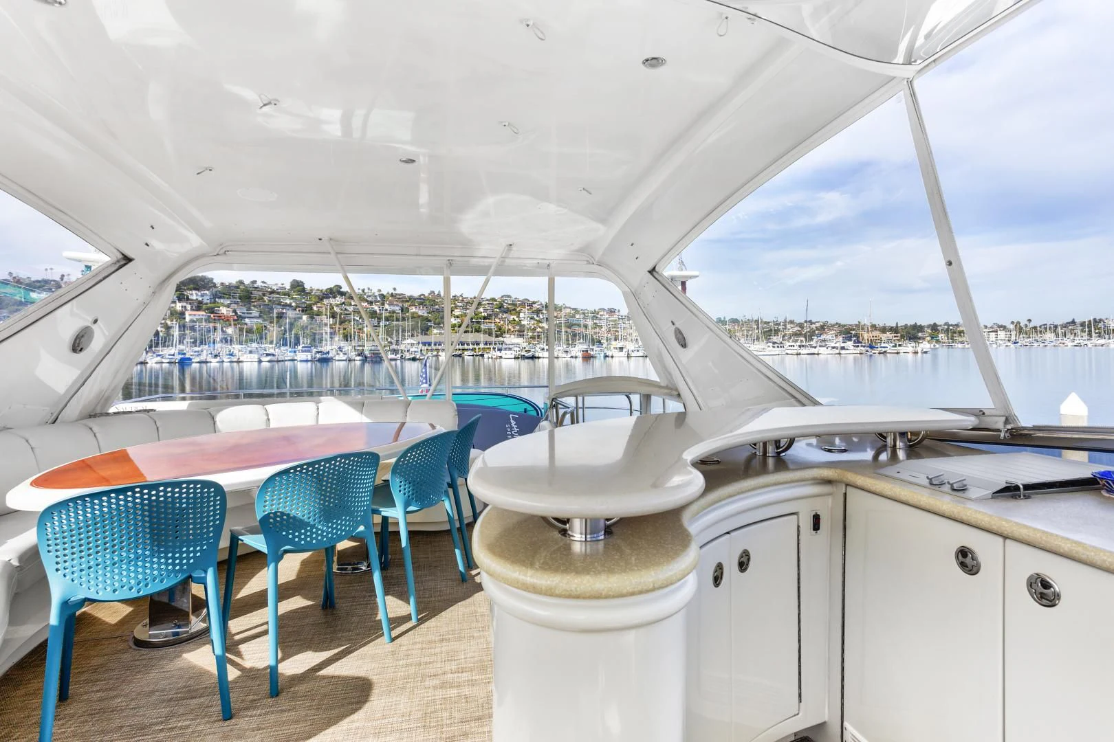 a large white boat with blue chairs aboard MONDRIAN Yacht for Sale