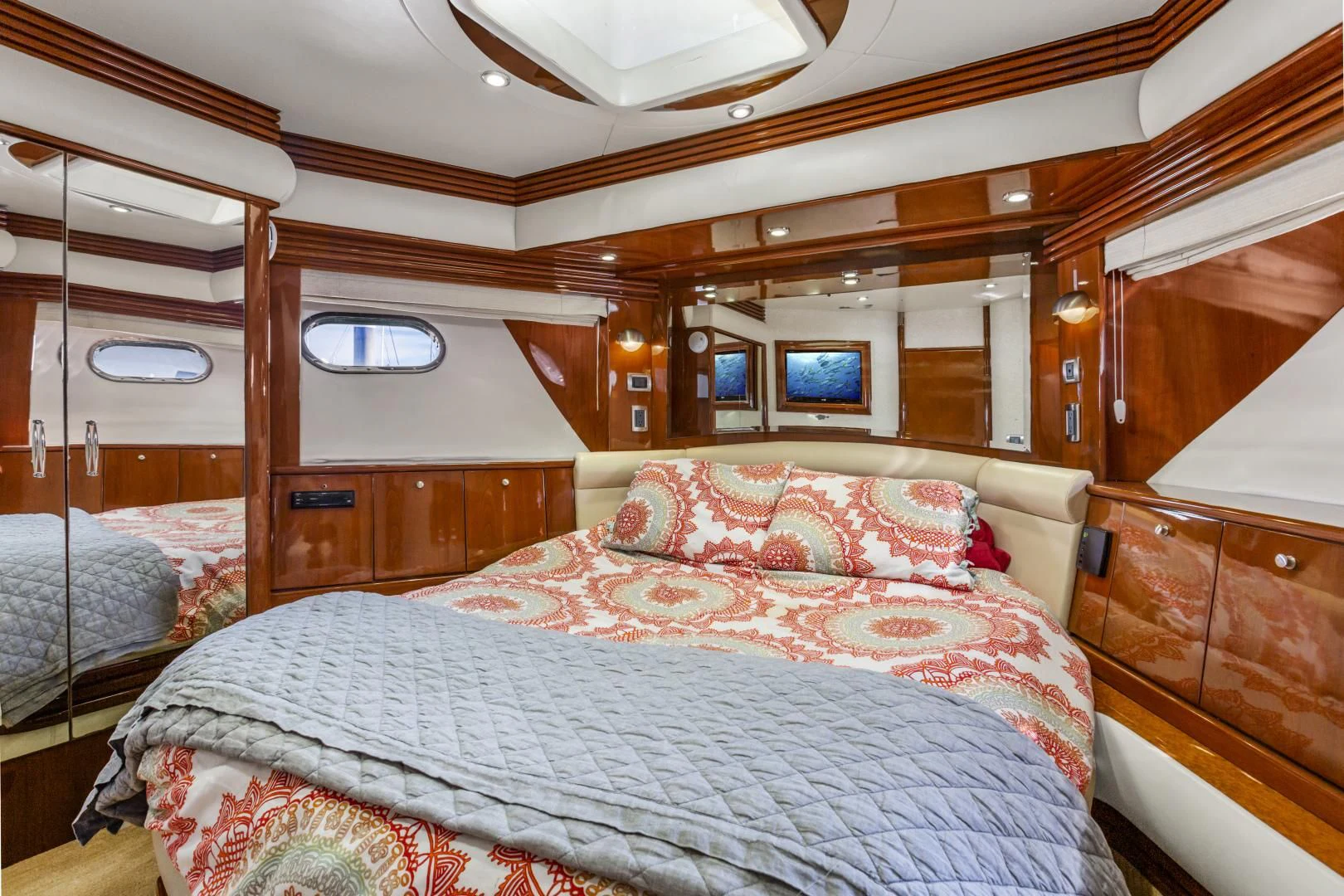 a room with a bed and a mirror aboard MONDRIAN Yacht for Sale