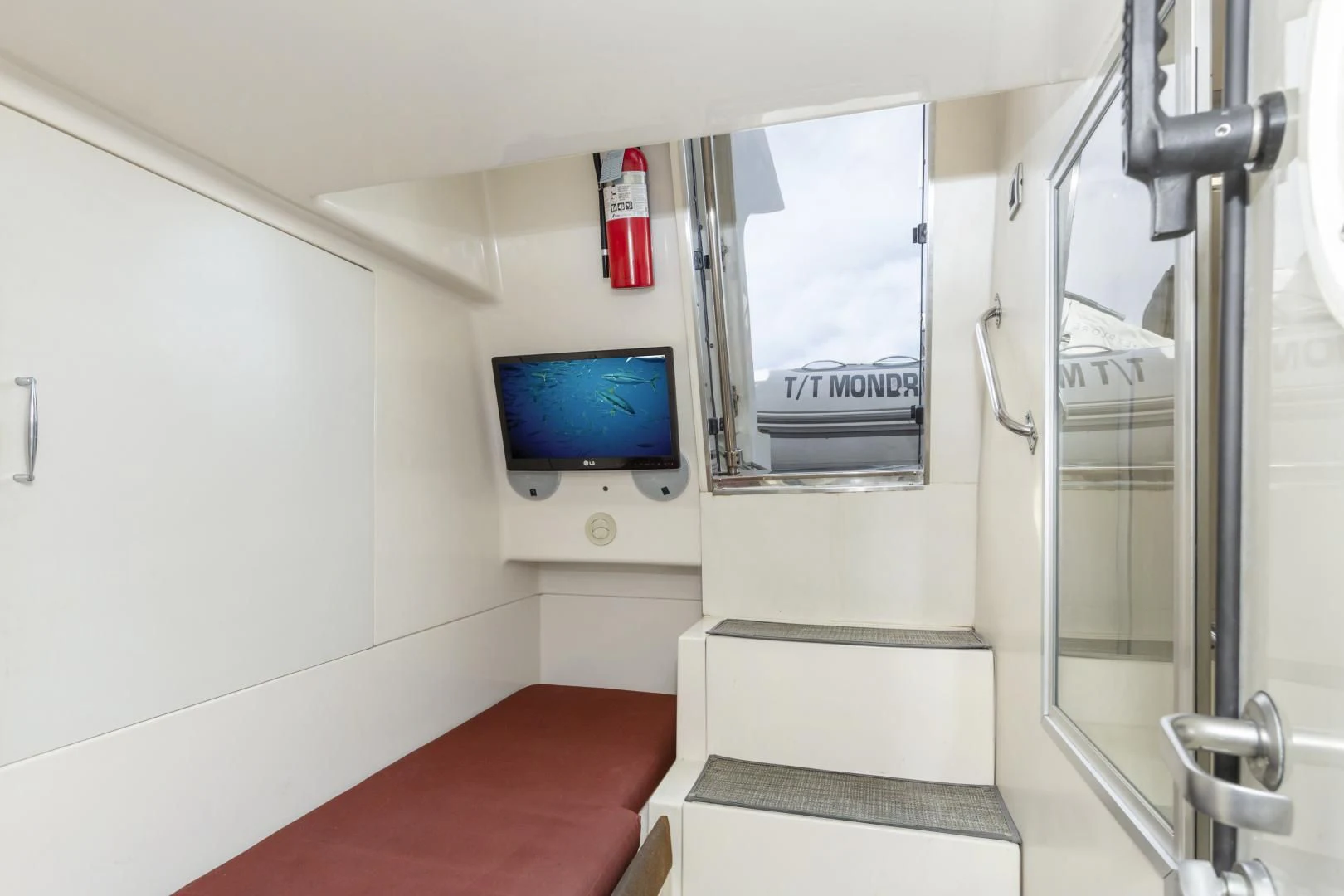 a room with a tv and a window aboard MONDRIAN Yacht for Sale