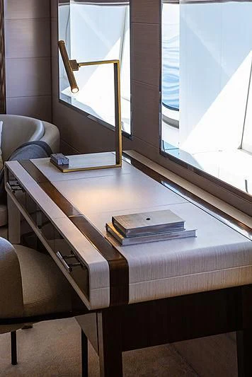 a desk with a book and a chair aboard MONT-AL LAWZ Yacht for Sale