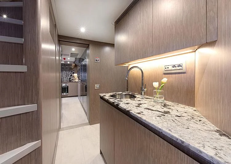 a kitchen with a countertop sink and cabinets aboard MONT-AL LAWZ Yacht for Sale