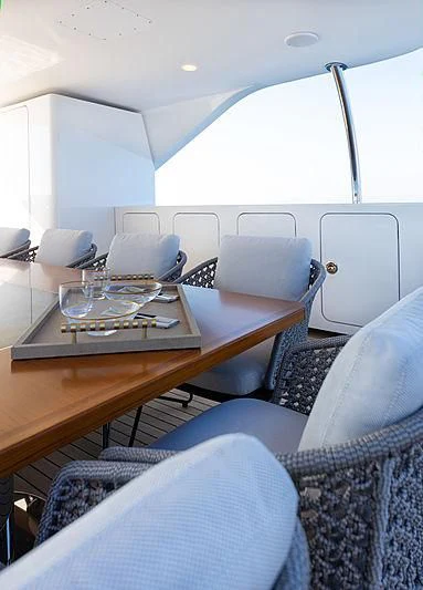 a table with chairs and a tray on it aboard MONT-AL LAWZ Yacht for Sale