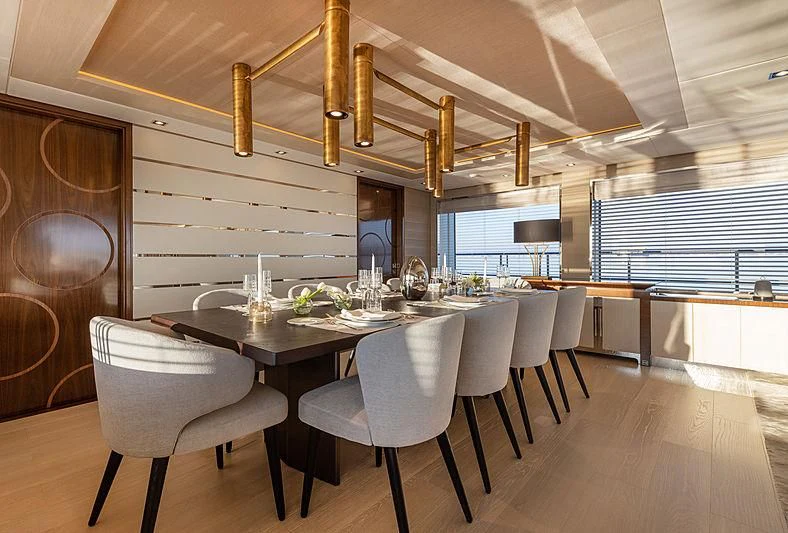 a large kitchen with white chairs aboard MONT-AL LAWZ Yacht for Sale