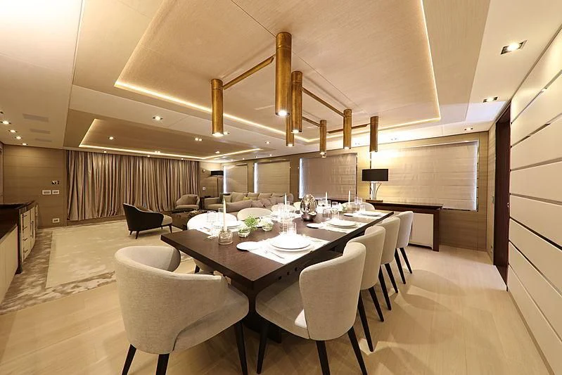 a large dining room with white chairs aboard MONT-AL LAWZ Yacht for Sale