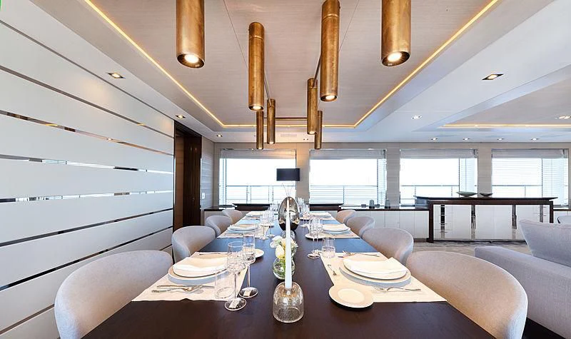 a dining room with a large window aboard MONT-AL LAWZ Yacht for Sale