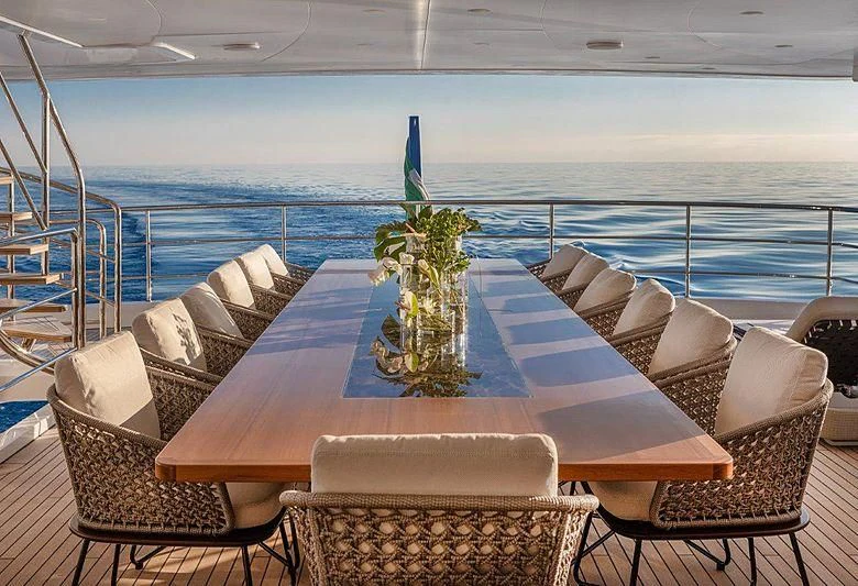 a table with chairs and a plant on it aboard MONT-AL LAWZ Yacht for Sale