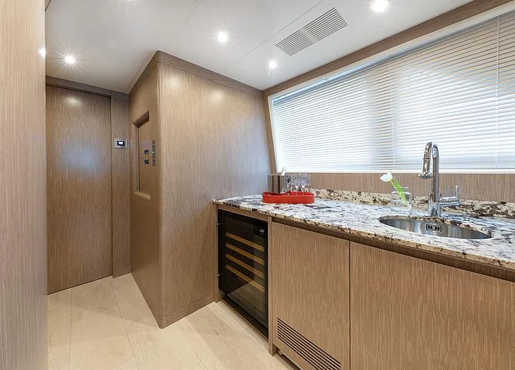 a kitchen with wooden cabinets aboard MONT-AL LAWZ Yacht for Sale