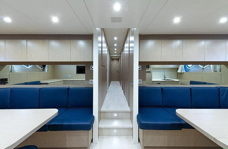 a room with a staircase and a table and chairs aboard MONT-AL LAWZ Yacht for Sale