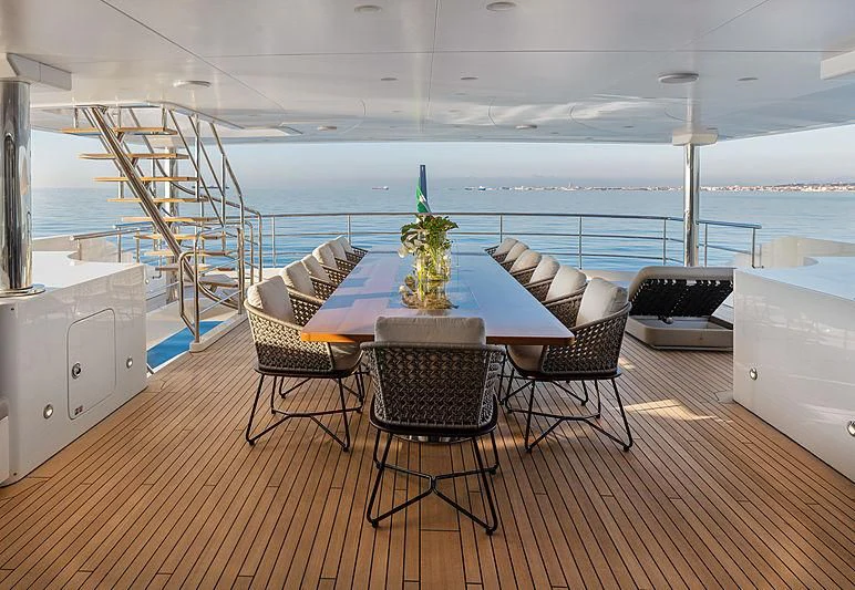 a room with a table chairs and a view of the ocean aboard MONT-AL LAWZ Yacht for Sale