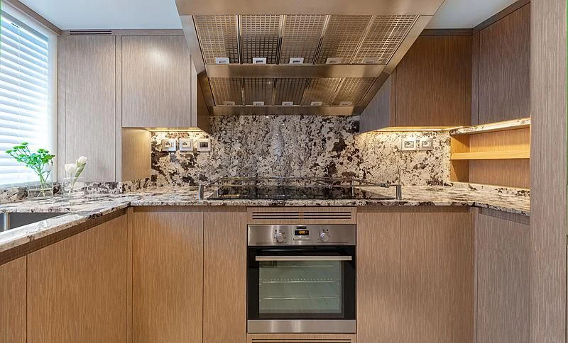 a kitchen with wooden cabinets aboard MONT-AL LAWZ Yacht for Sale