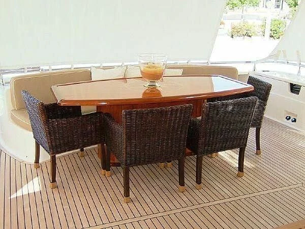 a table with chairs and a glass of beer on it aboard TIFFANY Yacht for Sale
