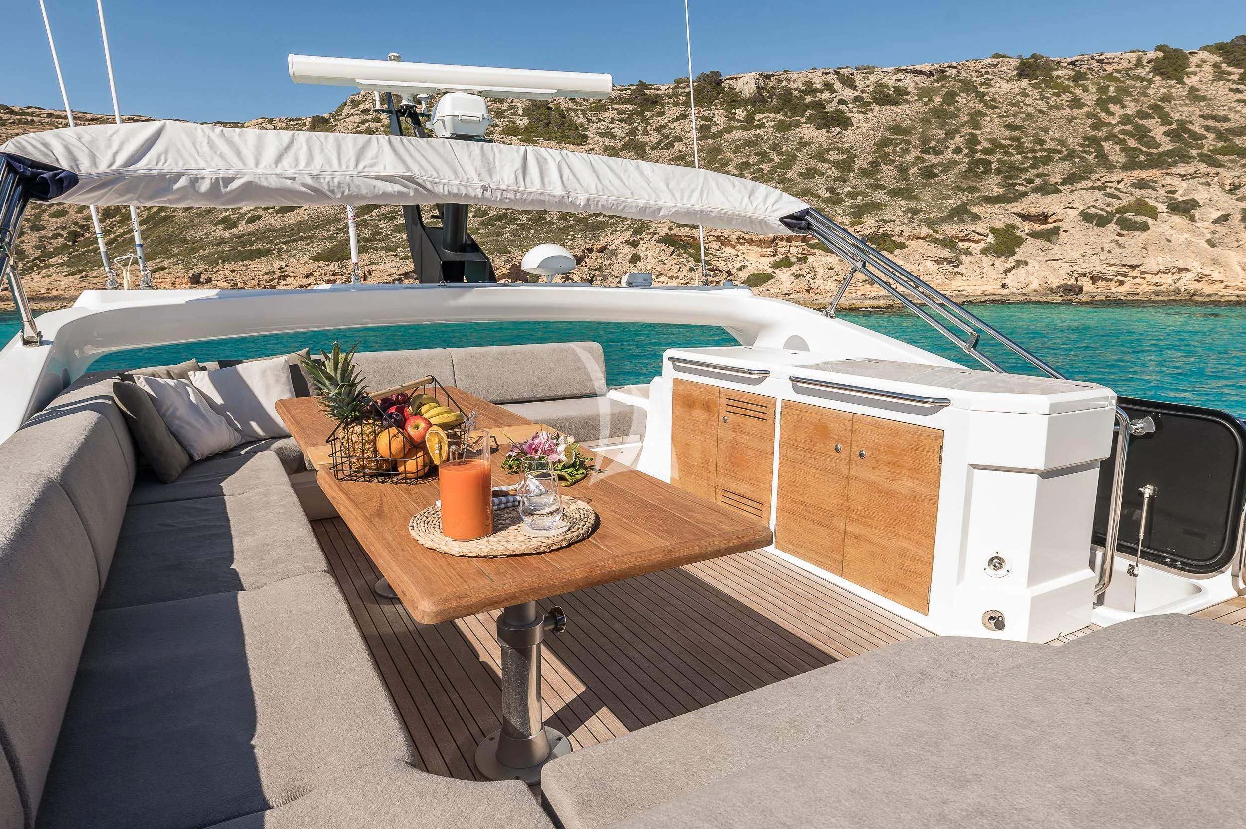 a table with a chair and a boat in the background aboard SEAWATER Yacht for Sale