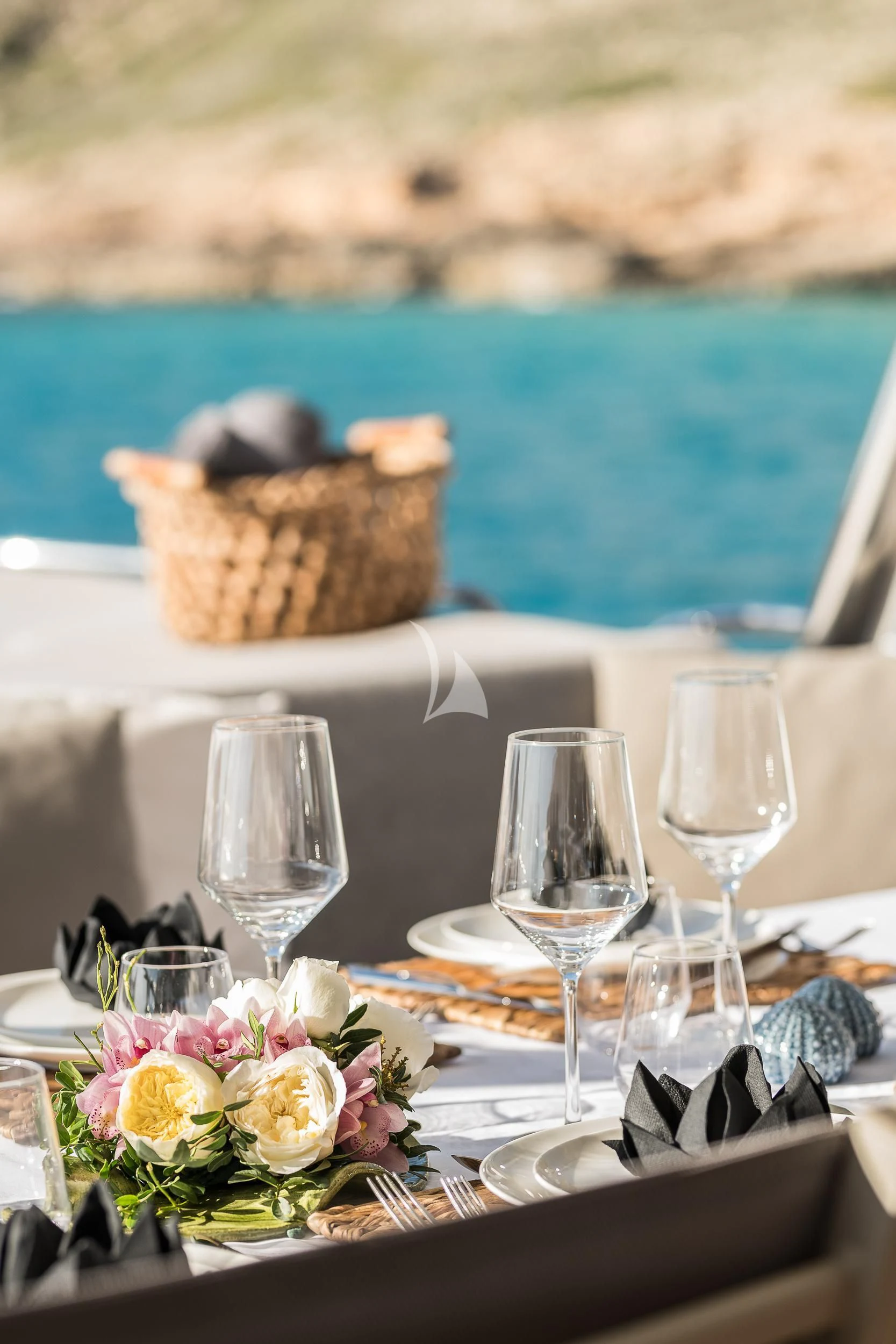 a table with glasses and flowers aboard SEAWATER Yacht for Sale