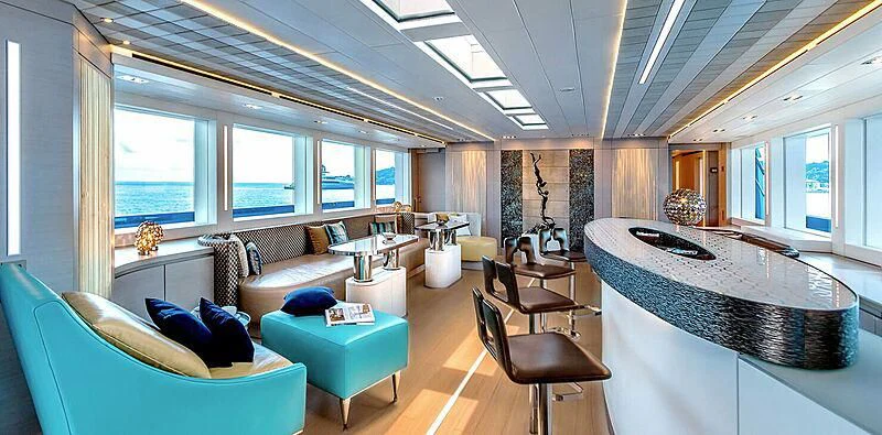 a living room with a large table and couches aboard QUEEN ALLA Yacht for Sale