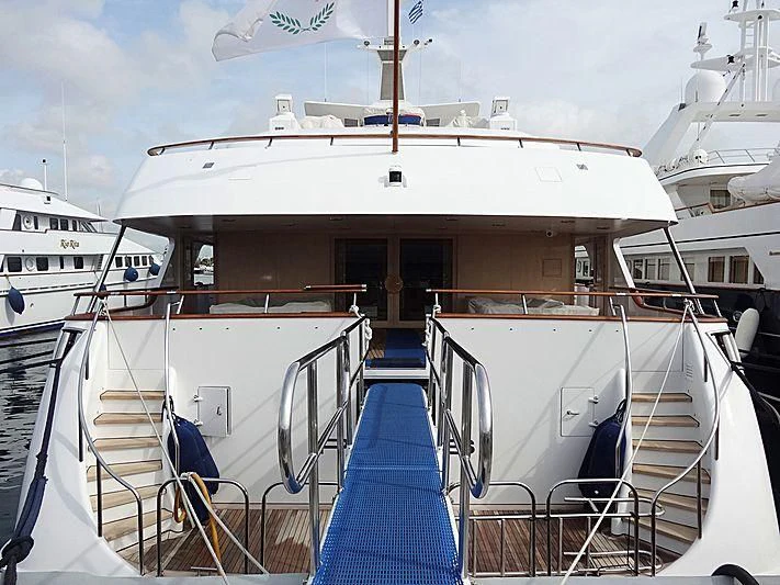 a large white boat with blue seats aboard PARIS Yacht for Sale