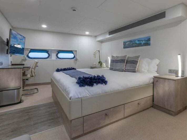 a bedroom with a large bed aboard CHASING ROMANCE Yacht for Sale
