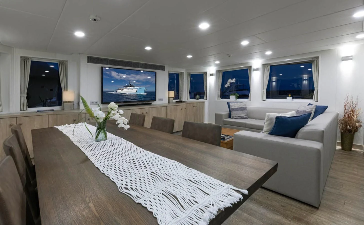 a large living room with a large bed and a flat screen tv aboard CHASING ROMANCE Yacht for Sale