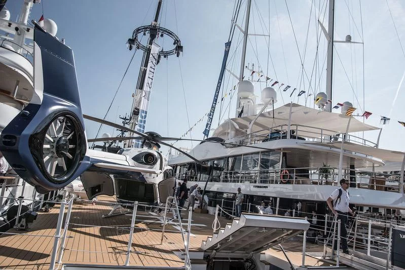 a boat docked with a boat in the background aboard CHASING ROMANCE Yacht for Sale