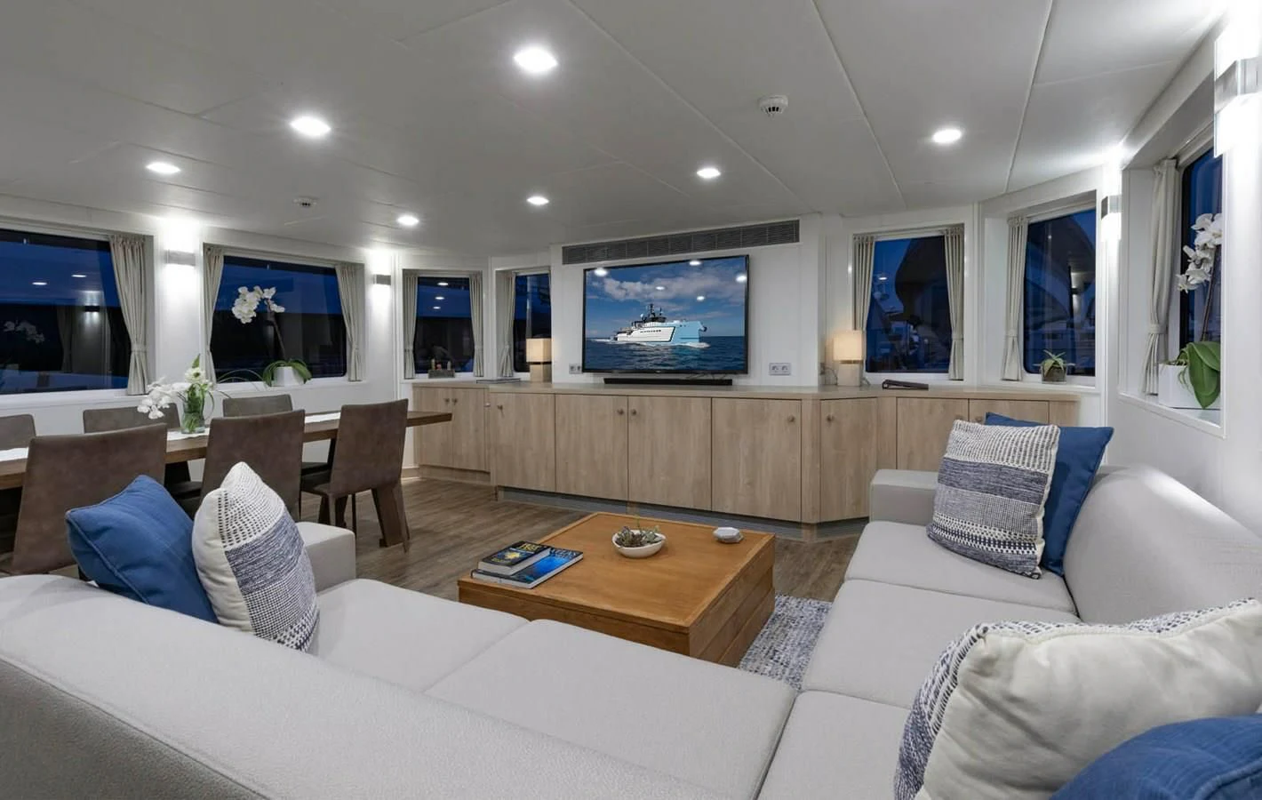 a living room with a large screen aboard CHASING ROMANCE Yacht for Sale