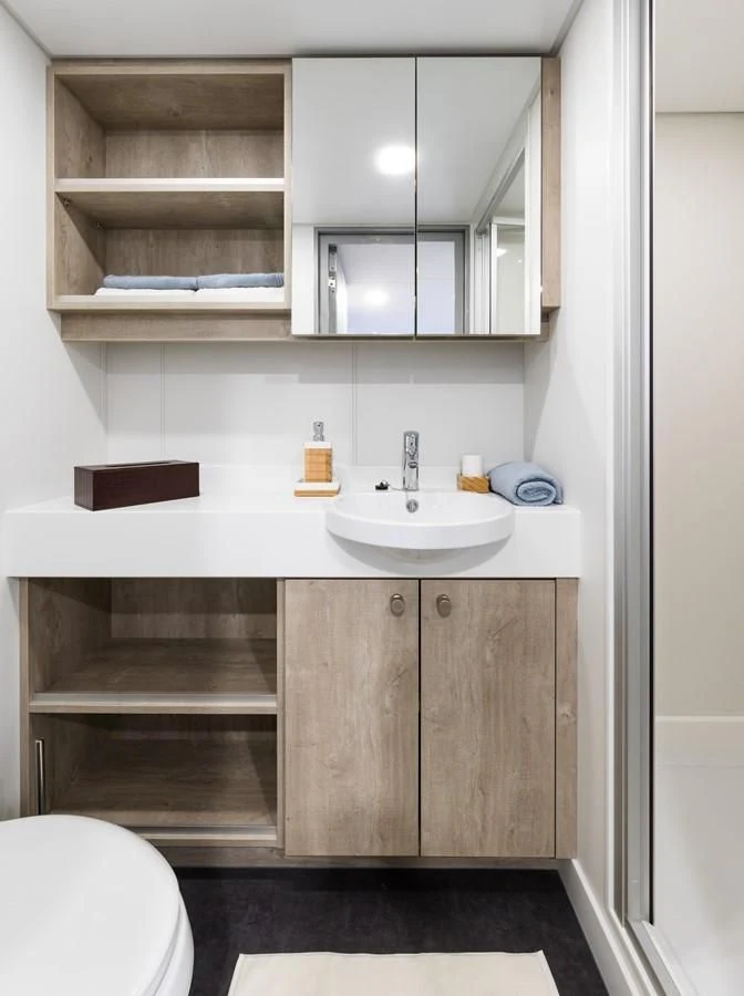a bathroom with a sink and cabinets aboard CHASING ROMANCE Yacht for Sale