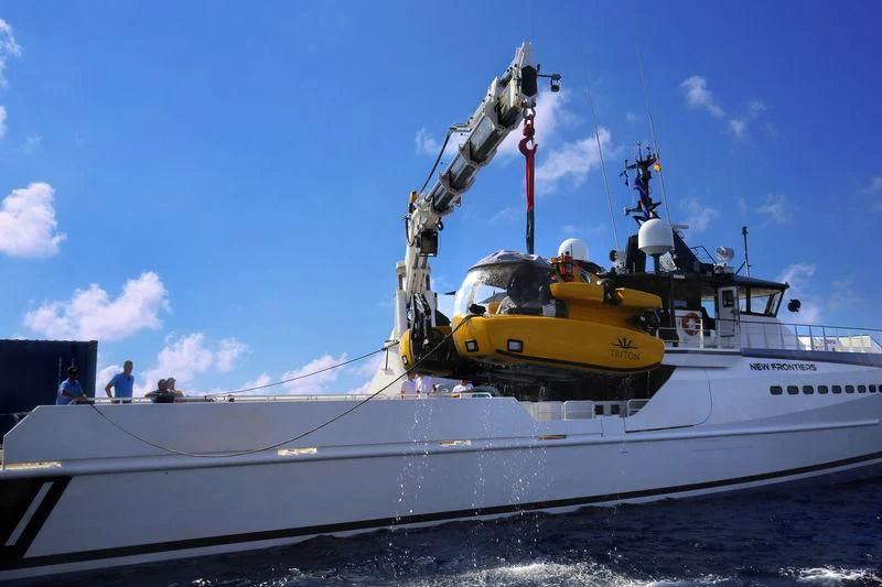 a large white boat with a crane on the front aboard CHASING ROMANCE Yacht for Sale