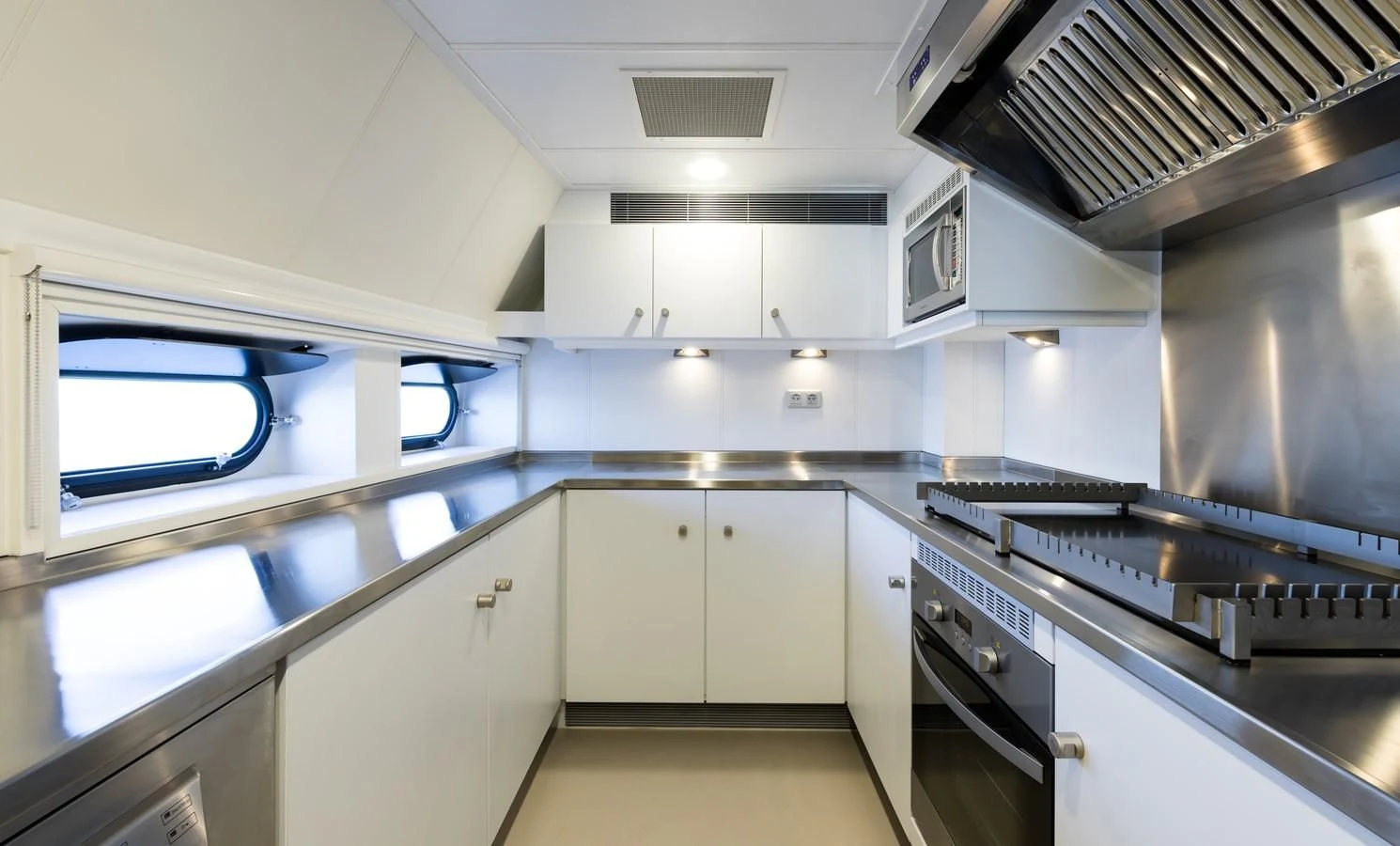 a kitchen with white cabinets aboard CHASING ROMANCE Yacht for Sale