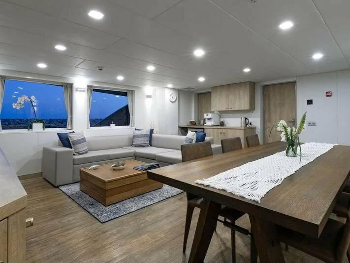 a living room with a large screen aboard CHASING ROMANCE Yacht for Sale
