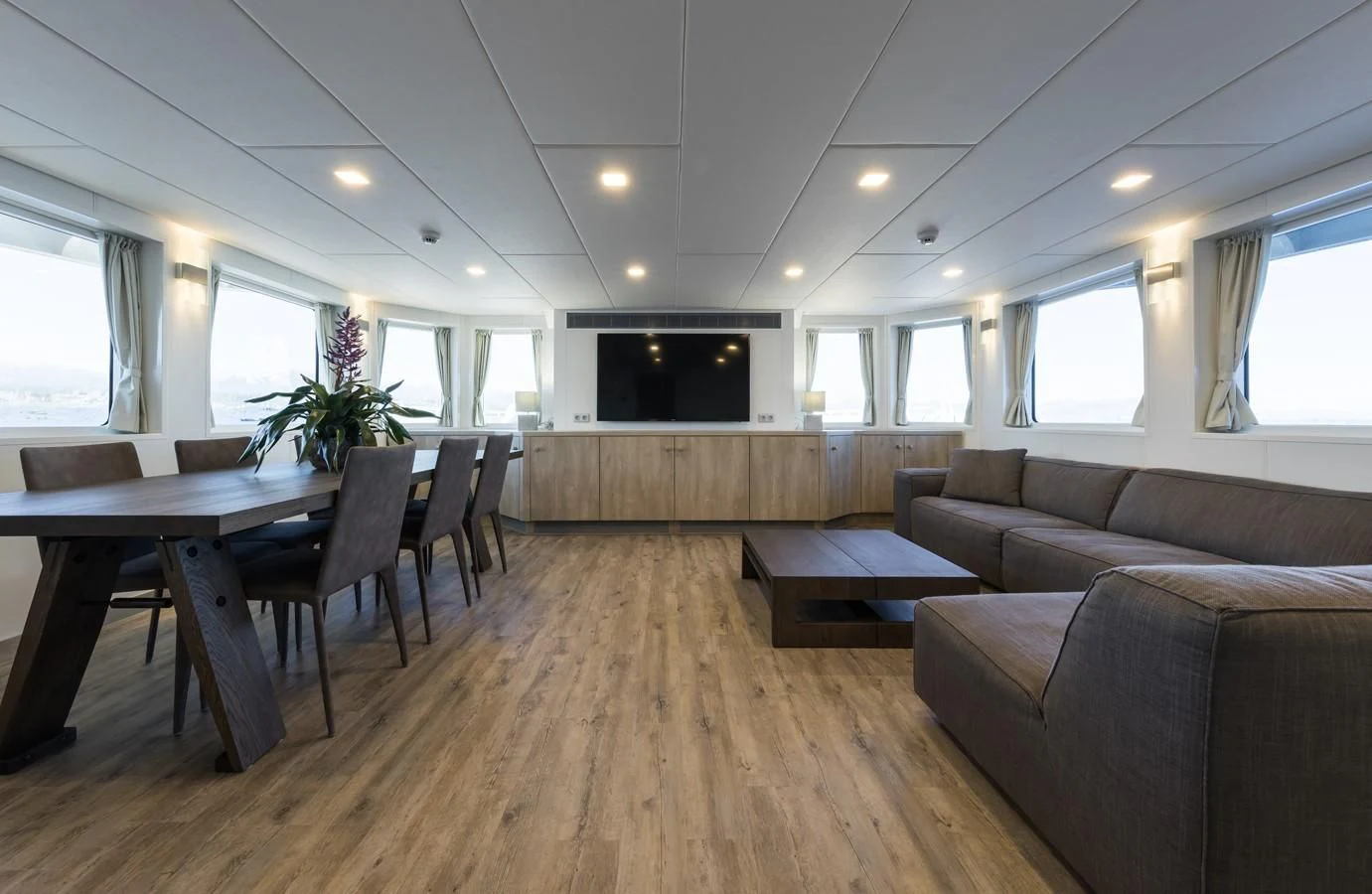a living room with a wood floor aboard CHASING ROMANCE Yacht for Sale