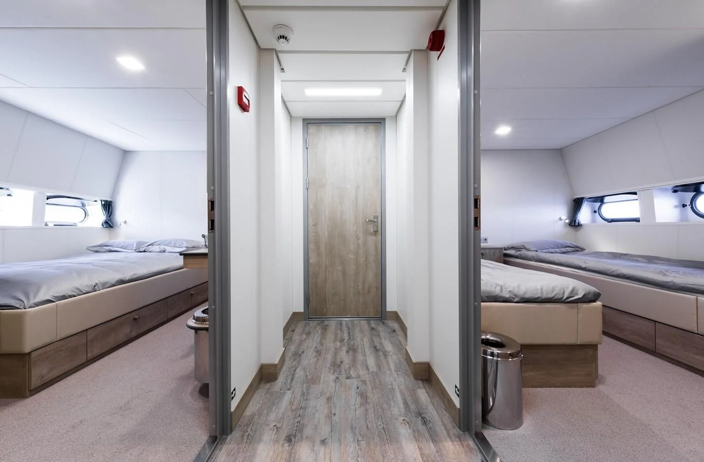 a room with beds and a trash can aboard CHASING ROMANCE Yacht for Sale
