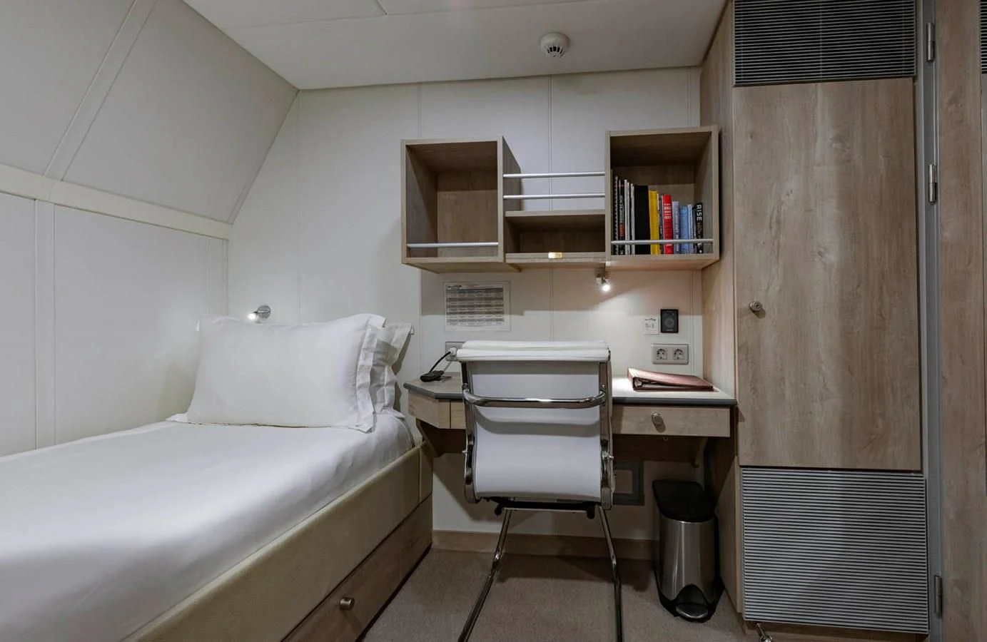 a room with a bed and a desk aboard CHASING ROMANCE Yacht for Sale