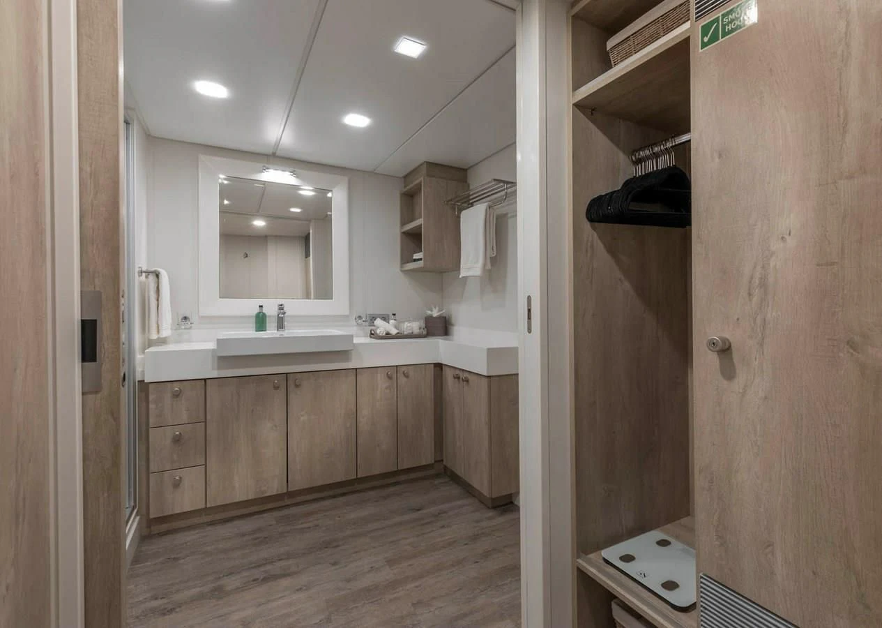 a bathroom with wooden cabinets aboard CHASING ROMANCE Yacht for Sale