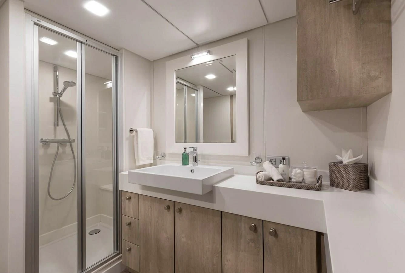 a bathroom with a glass shower aboard CHASING ROMANCE Yacht for Sale