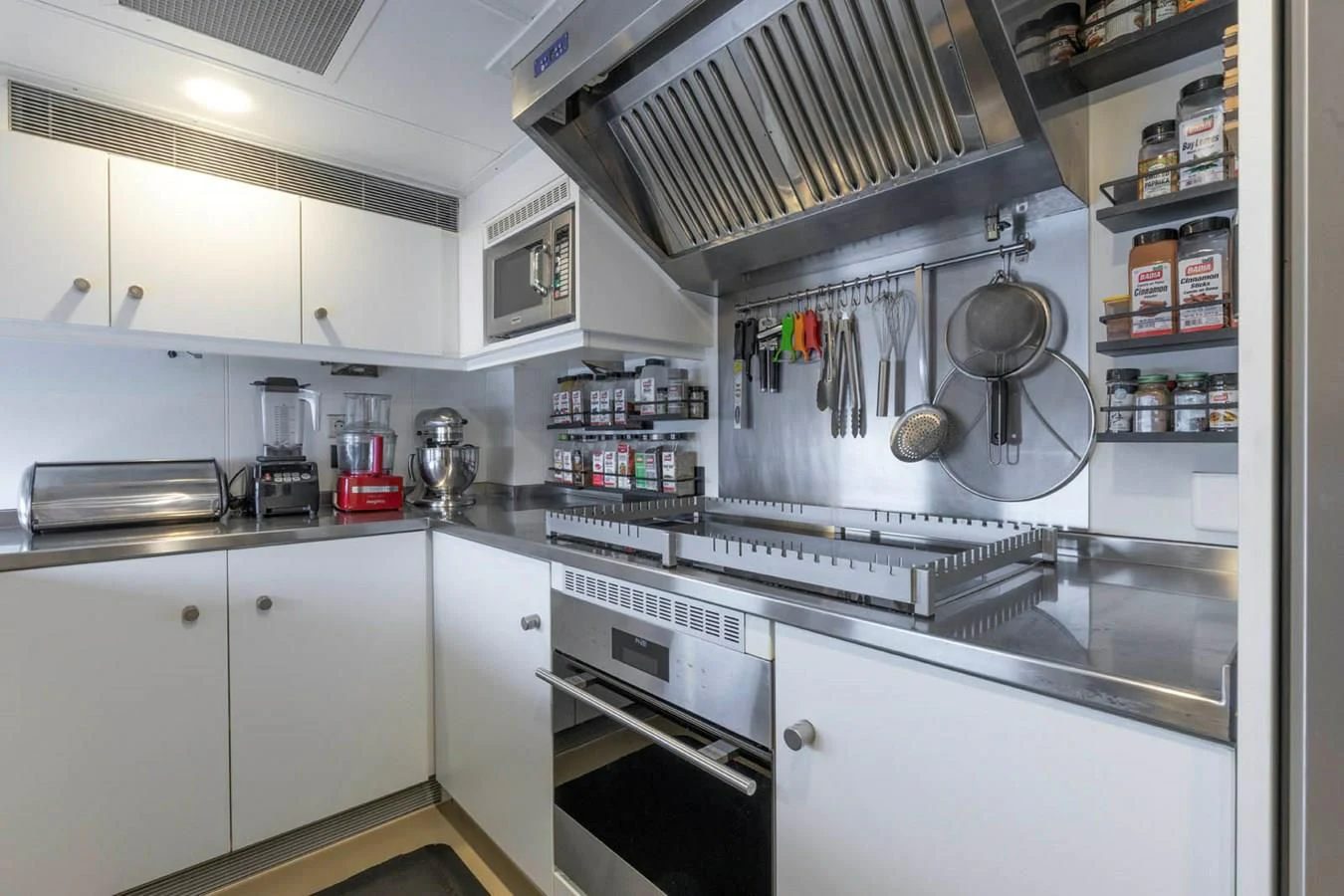 a kitchen with white cabinets aboard CHASING ROMANCE Yacht for Sale