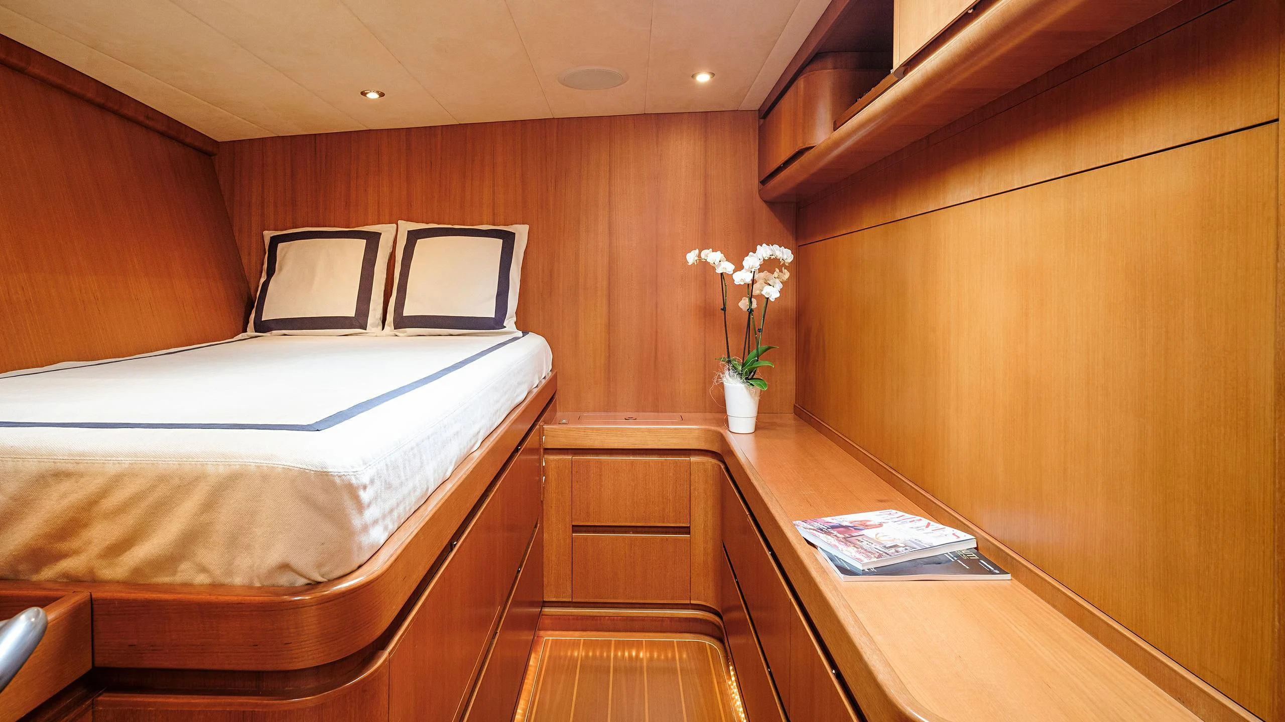 a room with a bed and desk aboard NINA I Yacht for Sale