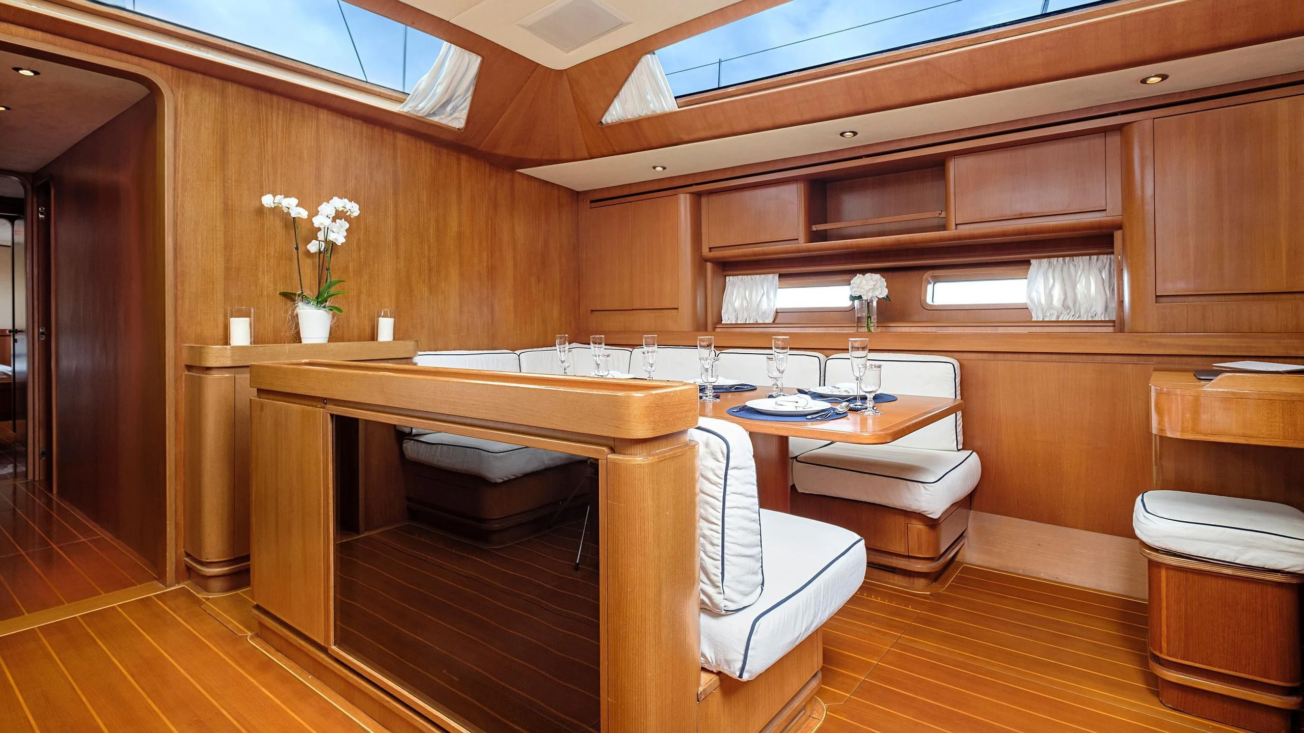 a room with a table and chairs aboard NINA I Yacht for Sale